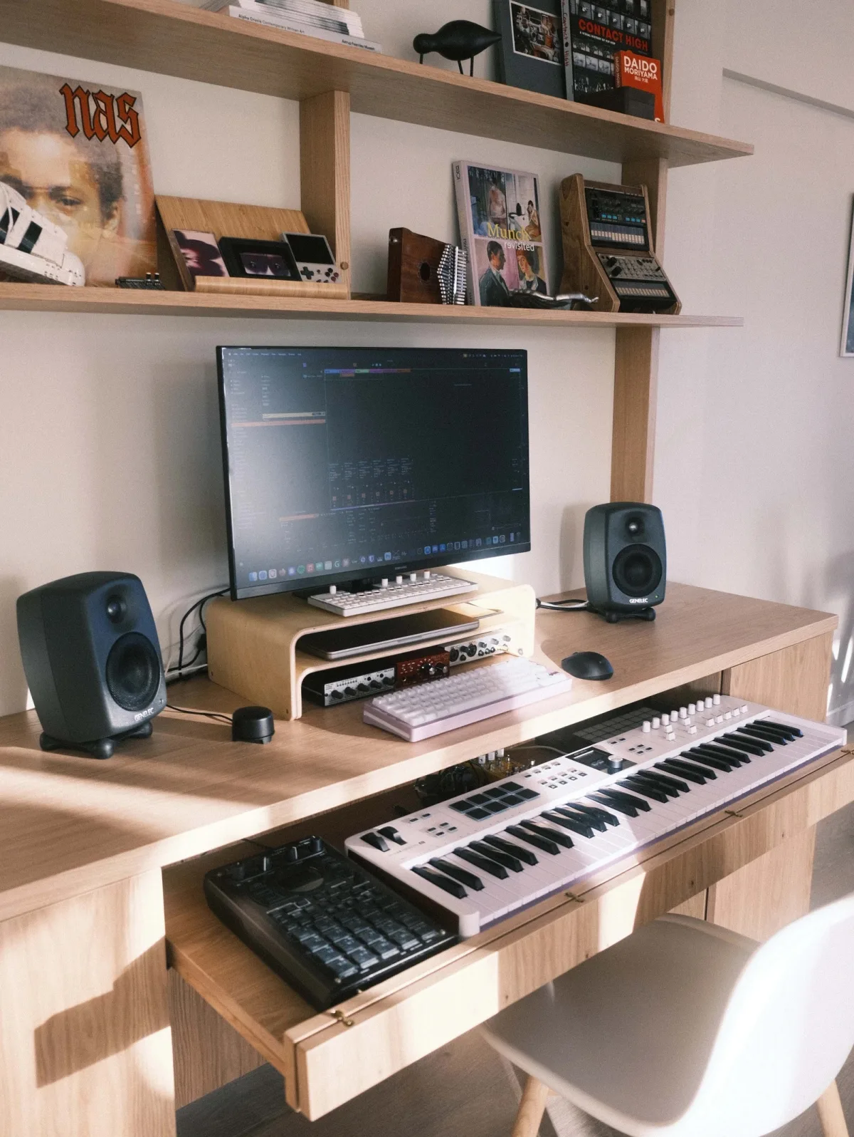 Kristoffer's studio desk with monitors, a laptop and shelves of records